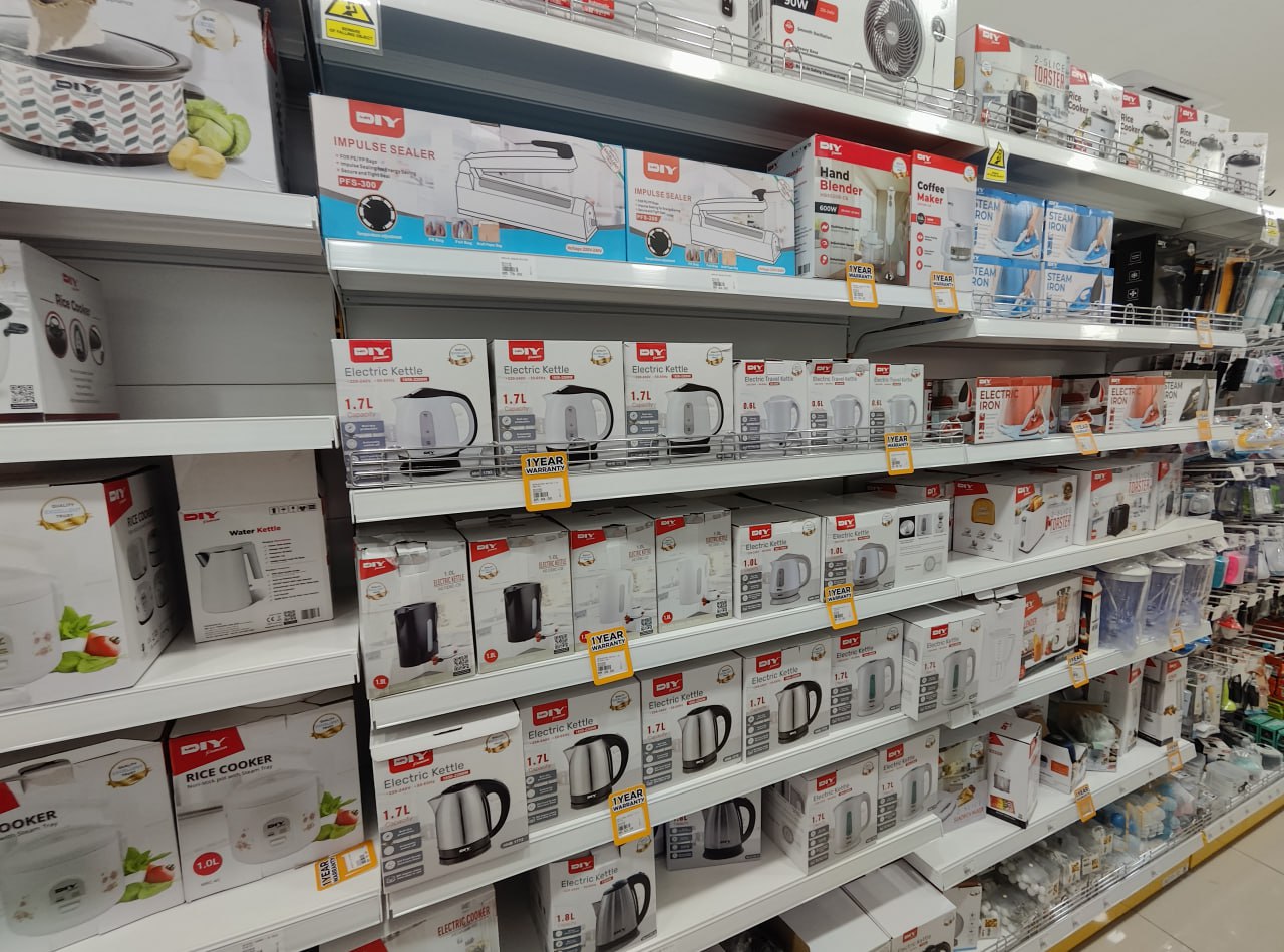 Это полка с электрическими кухонными приборами в магазине. На ней расположены различные модели электрических чайников, электрических кофеварок, электрических миксеров и других кухонных приборов. Все они